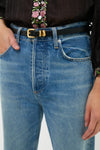 Close-up of a classic, high-end Black Hip to Waist Skinny Belt with a gold buckle, worn over light-wash jeans. The look is effortless and fun.