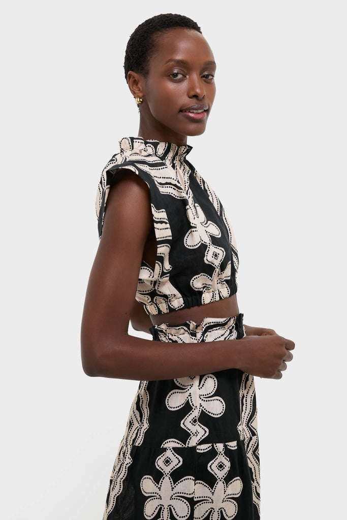 Woman models Niku Black Muna Ruched Crop Top, featuring classic, high-end abstract embroidery and ruched neckline. Effortless, fun design with elastic waist for comfort.