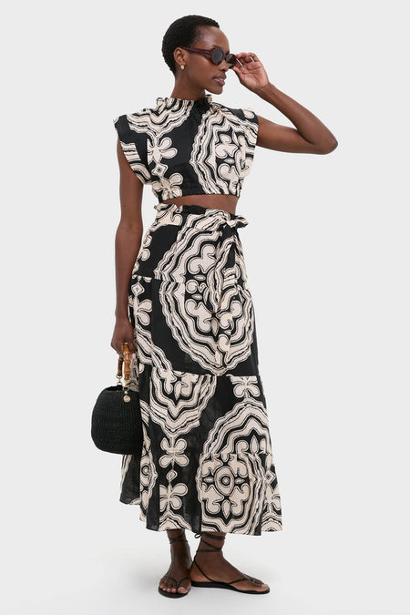 Model wearing Niku Black Muna Ruched Crop Top, featuring a classic, high-end abstract print, ruched neckline, and back tie, paired with a matching skirt for an effortless, fun look.