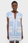 Woman modeling the classic Debre Sky Elina Caftan, an effortless, high-end tunic dress with a V-neck, cap sleeves, and bold horizontal stripes.