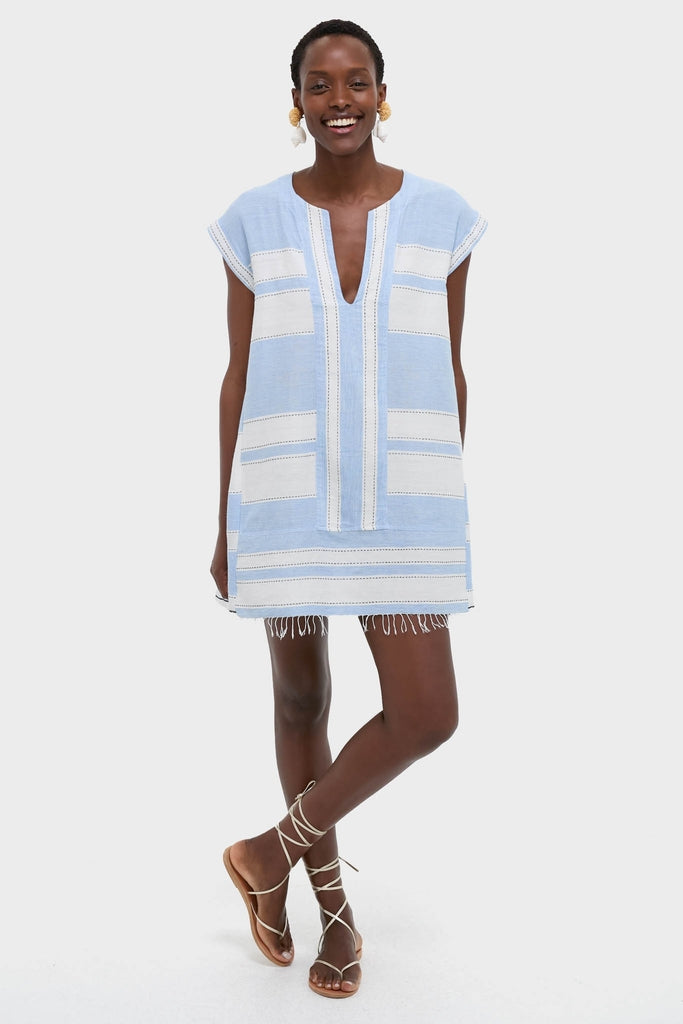 Person wearing the Debre Sky Elina Caftan, a classic, effortlessly fun, high-end tunic with a V-neck, fringed hem, and lace-up sandals, embodying a chic, relaxed style.