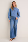 Indigo Denim Margot Top: Classic, effortless style with a rounded collar and gold hammered buttons, paired with matching denim jeans for a fun, high-end look.