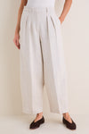 Model wearing Mortar Melange Dash Pants, classic wide-leg culottes with pleats and cropped barrel-leg design, paired with flats for an effortless, high-end look.