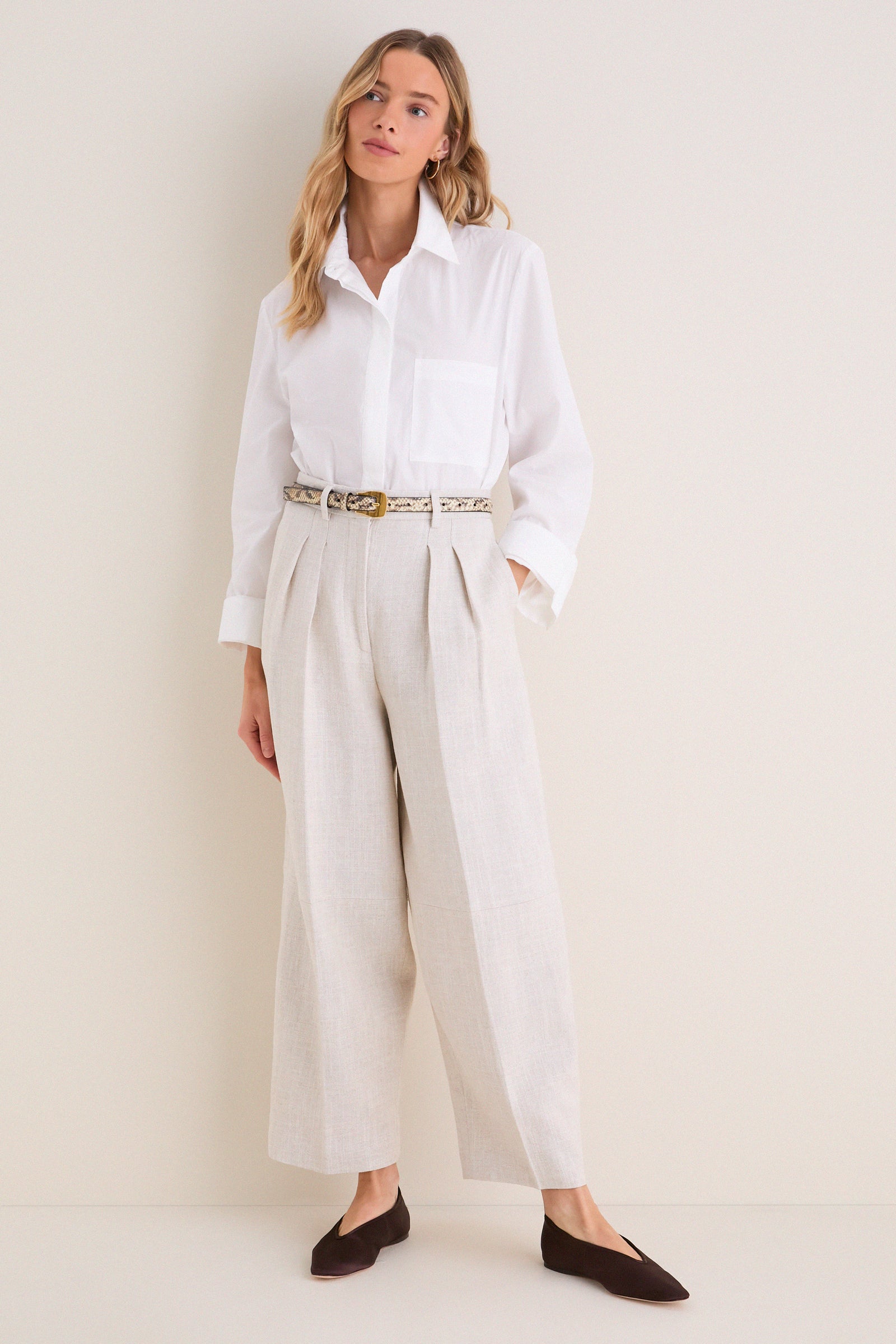 Model in classic Mortar Melange Dash Pants, showcasing an effortless, high-end look with pleated, barrel-leg style, paired with a white shirt and chic accessories.