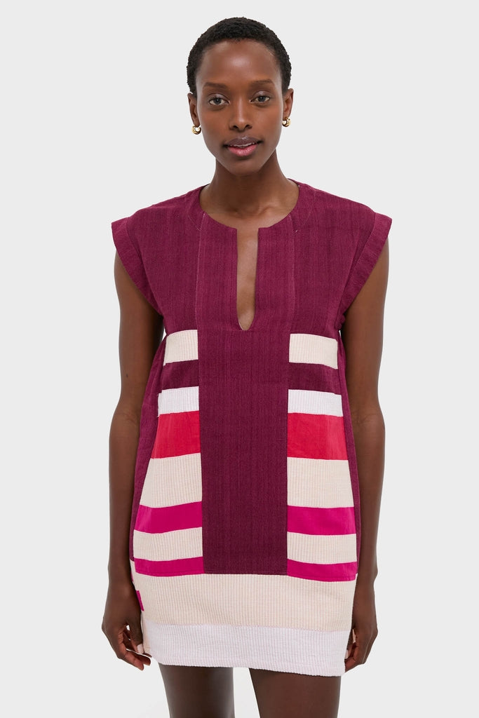 Model in a classic, effortless Betami Cherry Elina Caftan, showcasing burgundy with vibrant side stripes. A fun, high-end look from Tuckernuck for versatile vacation style.