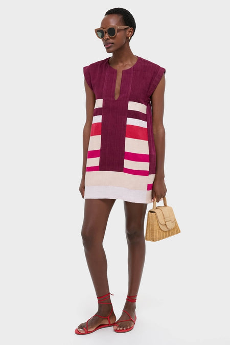 A dark-skinned woman models the Betami Cherry Elina Caftan, embodying effortless, high-end fashion with its classic A-line silhouette and striking color-block design.