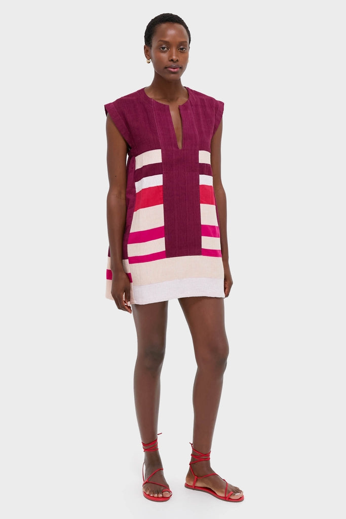 Model wears the classic Betami Cherry Elina Caftan, an effortless tunic dress with color-block stripes, paired with red sandals and gold hoops for a fun, high-end look.