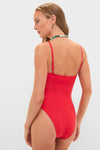 Woman in a classic, high-end Ruby Jenna One Piece swimsuit with adjustable straps, accessorized with a beaded necklace and gold hoops, embodying an effortless, fun style.