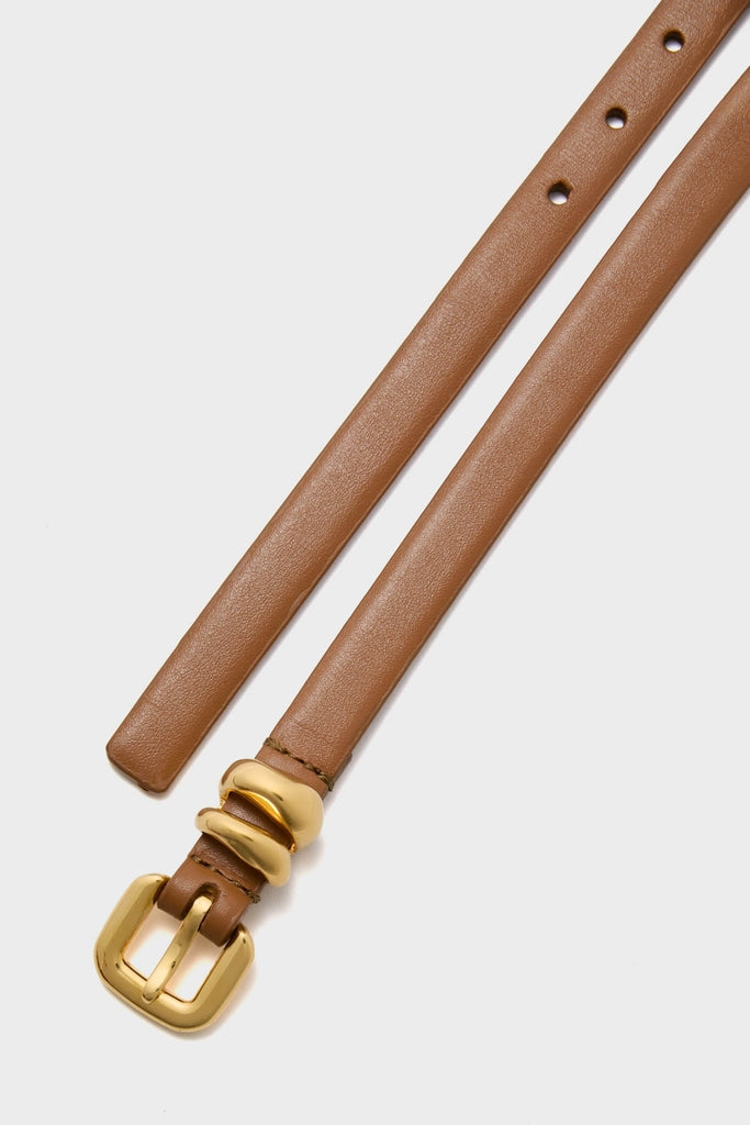 Saddle Hip to Waist Skinny Belt featuring a classic, effortless design with a polished gold-tone buckle and loops, perfect for a high-end, fun look.