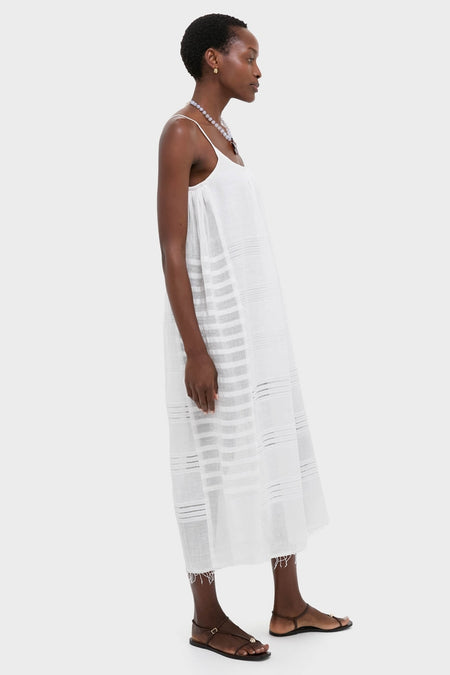 Effortlessly elegant, the Abira White Nia Slip Dress features a classic scooped neckline, shimmering silver dots, and relaxed fit, perfect for a fun, high-end getaway.