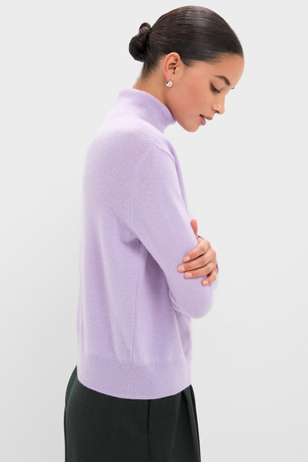Person in profile wearing the Lavender Frost Cashmere Turtleneck Sweater, epitomizing classic, effortless style with a high-end touch, perfect for any fun, confident outing.