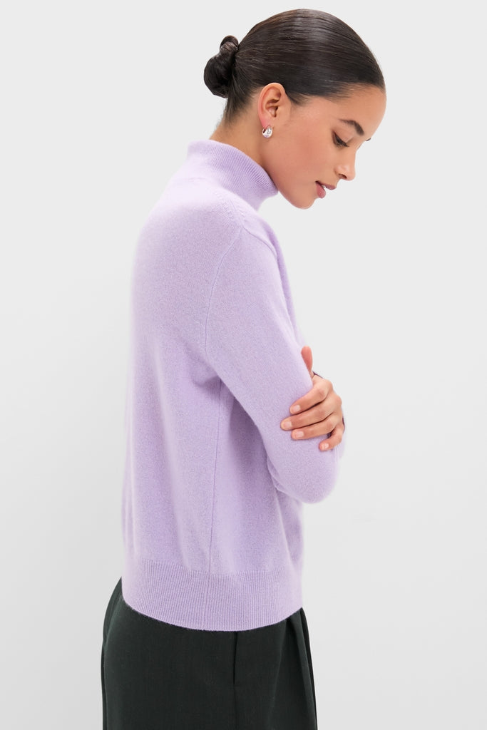 Person in profile wearing the Lavender Frost Cashmere Turtleneck Sweater, epitomizing classic, effortless style with a high-end touch, perfect for any fun, confident outing.