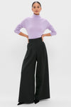 Model wearing the Lavender Frost Cashmere Turtleneck Sweater, styled with high-waisted black trousers and pointed-toe shoes, showcasing a classic, effortless, and high-end fashion look.