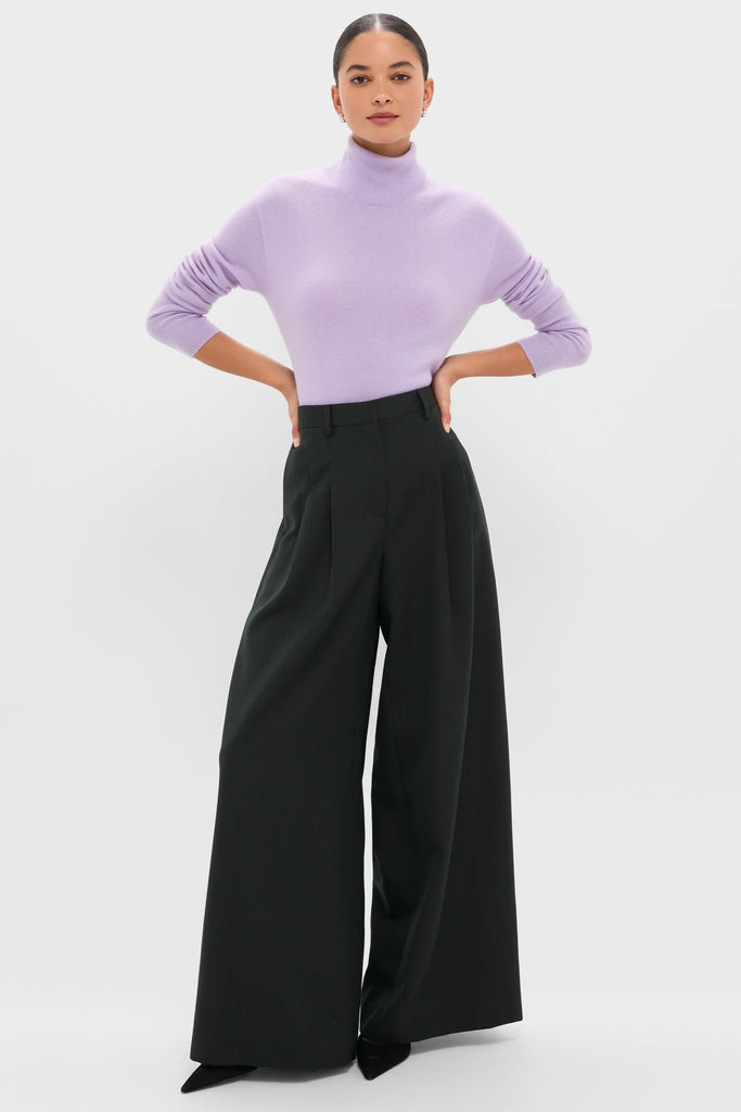 Model wearing the Lavender Frost Cashmere Turtleneck Sweater, styled with high-waisted black trousers and pointed-toe shoes, showcasing a classic, effortless, and high-end fashion look.