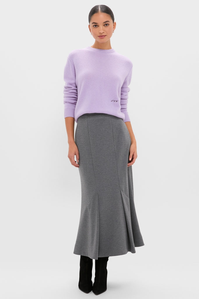 Woman wearing classic Lavender Frost Cashmere Boyfriend Bodie Crewneck Sweater, styled effortlessly with a high-end charcoal skirt and pointed-toe boots, reflecting fun, confident elegance.