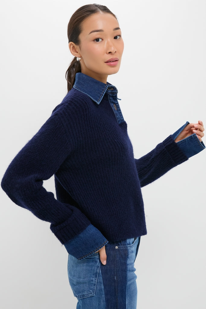 Woman models the classic Navy and Denim Harvey Sweater with denim collar and cuffs, paired with jeans, showcasing an effortless, high-end look perfect for fun, everyday wear.