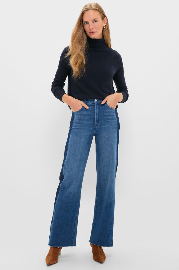 Model wearing American Dream High Rise Column Jean, showcasing a classic, effortless look with a high-rise, two-tone design, paired with a navy turtleneck and suede boots.