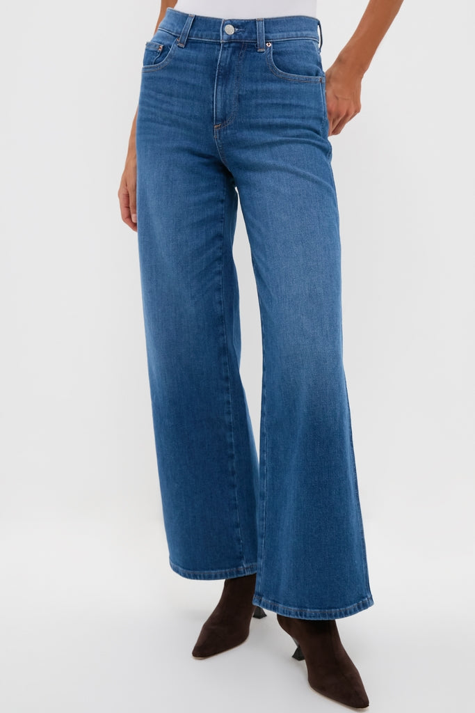 Juliette High Rise Wideleg jeans with classic five-pocket styling and wide-leg flare, effortlessly revealing dark brown boots for a high-end, fun look.