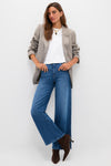 Woman in a classic, effortless ensemble featuring LE JEAN's London Calling Juliette High Rise Wideleg jeans, exuding a fun and high-end style.