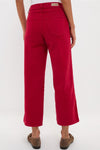 Model showcases classic Red Juliette High Rise Wideleg Ankle jeans, effortlessly styled with brown suede loafers, highlighting high-end, fitted design through hips, perfect for any occasion.