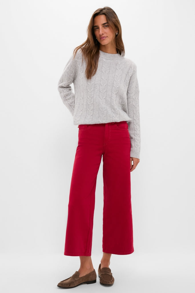 Woman models classic Red Juliette High Rise Wideleg Ankle, effortlessly styled with a light gray sweater and brown loafers, embodying high-end, fun fashion.