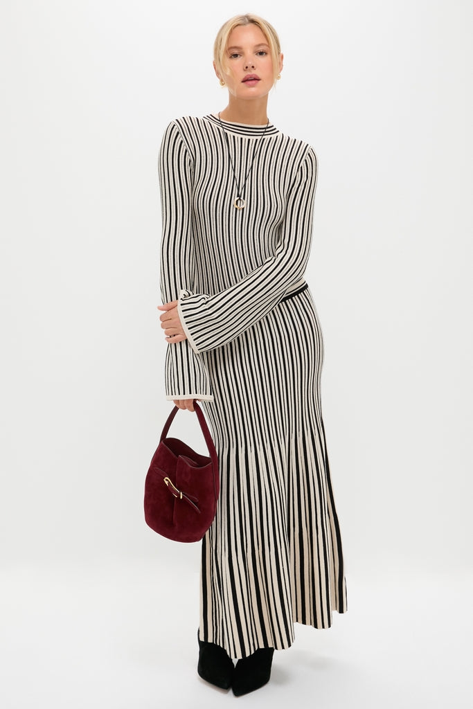 Woman models classic, effortlessly chic ribbed knit dress. She wears the Mixed Lucy Williams Entwine Pendant Cord Necklace, adding a fun, high-end touch.