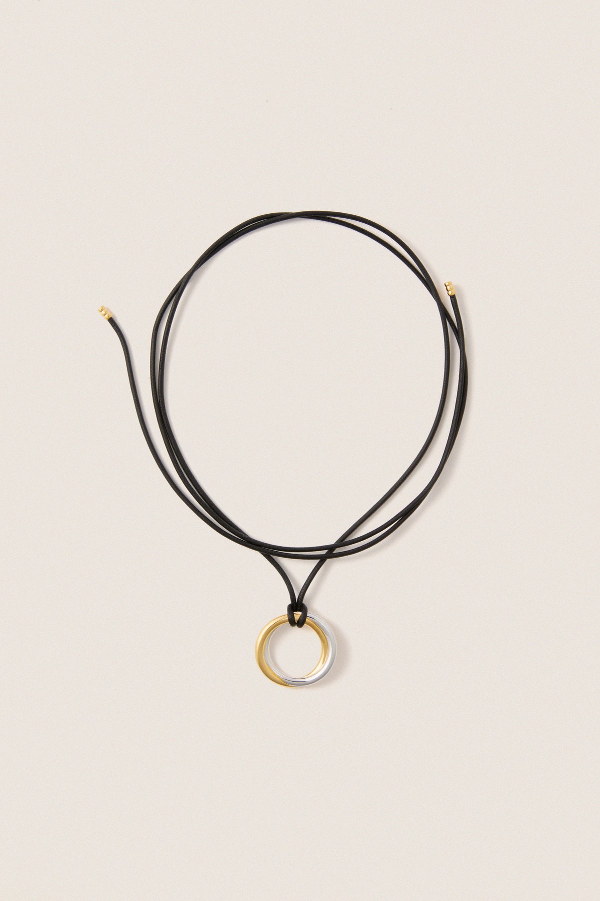 Mixed Lucy Williams Entwine Pendant Cord Necklace features a classic, effortless design with two-tone rings on an adjustable black cord, offering a fun, high-end look.