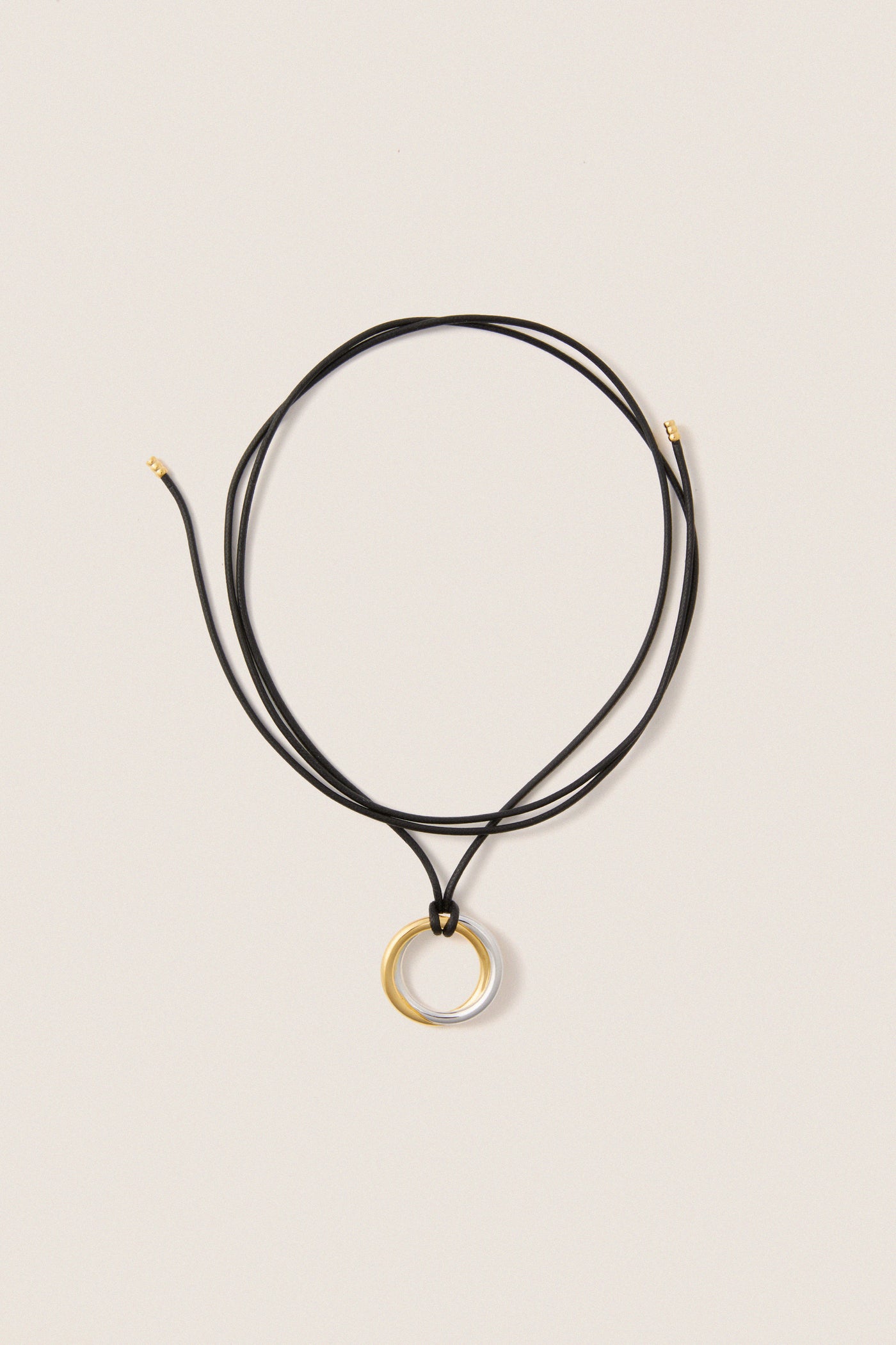 Mixed Lucy Williams Entwine Pendant Cord Necklace features a classic, effortless design with two-tone rings on an adjustable black cord, offering a fun, high-end look.