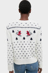 Person wearing Ski Lodge Crew Sweater with classic alpine motifs, featuring navy geometric patterns and intarsia knit skiers, styled effortlessly with jeans for a high-end, fun look.