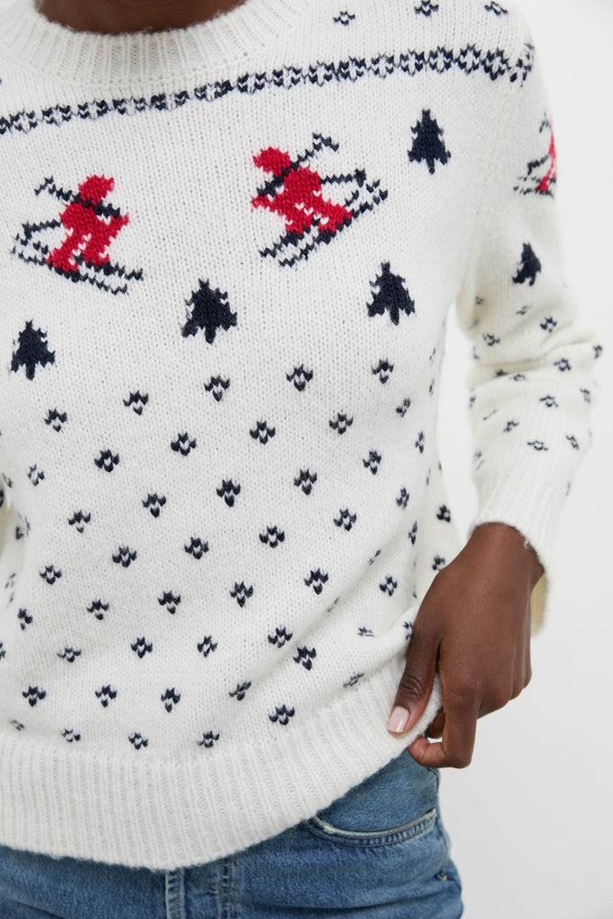 Cozy Ski Lodge Crew Sweater with classic alpine motifs and intarsia knit skiers, effortlessly styled with denim for a fun, high-end winter look.