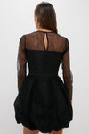 Black Saoirse Mini Dress with dotted mesh, sheer sleeves, and bubble hem, styled effortlessly for a modern, fun, and high-end look. Classic elegance reimagined.