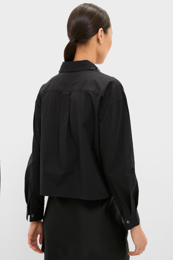 Person models the Black Embellished Cropped Jasper Button Down, showcasing its classic, effortless style with gem-embellished collar and scalloped slit, ideal for high-end versatility.