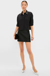 Model wearing the Black Embellished Cropped Jasper Button Down with crystal collar details, paired with an A-line skirt and silver heels, exuding effortless, high-end style.