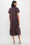 The Tartan Martine Maxi Bubble Dress features a classic plaid pattern with an effortless bubble hem, perfectly styled with sparkly heels for a fun, high-end look.