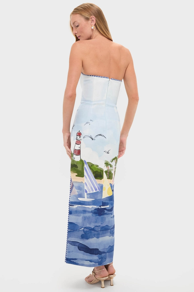 Model in profile wearing the Nautical Print Ava Bustier Maxi Dress with seaside motifs, embodying an effortless, classic style. Perfect for high-end, fun occasions.