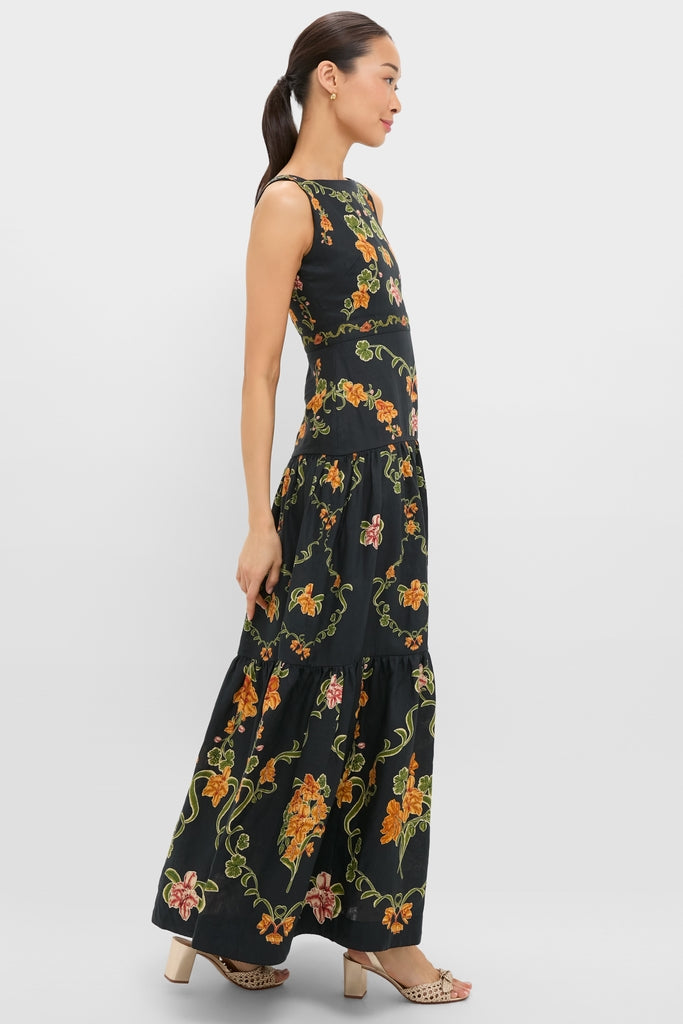 A slender woman exudes effortless elegance in the Cordillera Abeja Maxi Dress, featuring a classic floral print, perfect for a high-end, fun, and confident look.
