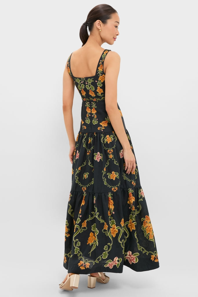 Woman in a classic, sleeveless Cordillera Abeja Maxi Dress with vibrant floral print, showcasing an effortless, high-end style, perfect for a fun and confident look.