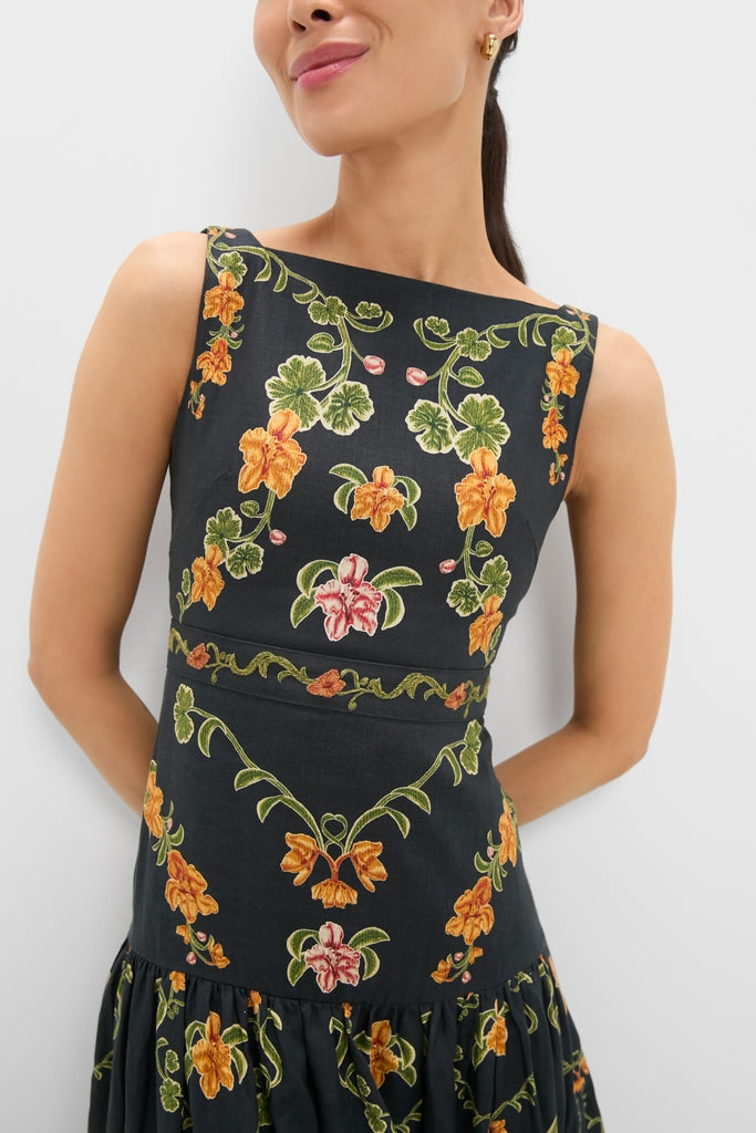 Cordillera Abeja Maxi Dress: A classic, sleeveless black dress with effortless floral embroidery, featuring orange and yellow blooms, embodying a fun, high-end aesthetic from Tuckernuck.