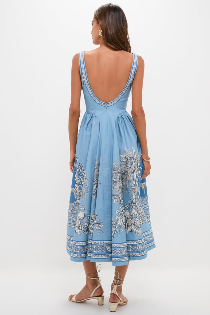 Model in Blue Villa Romantica Midi Dress featuring a plunging back, botanical print, paired with gold sandals. A classic, effortless look for high-end, fun occasions.