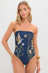 Laguna Durazno Embroidered One Piece: A classic strapless navy swimsuit with floral and heron motifs, embodying effortless, high-end elegance and fun, perfect for poolside lounging.