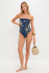 Laguna Durazno Embroidered One Piece: Classic, high-end navy swimsuit with floral and crane motifs, effortlessly styled with a straw handbag and bangle, showcasing fun, elegant details.