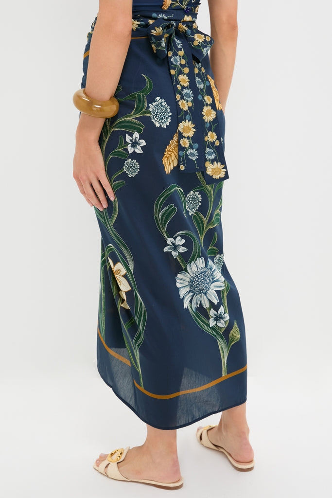 Laguna Lavanda Midi Sarong with classic botanical motifs, tied elegantly at the back, paired with a chunky bangle and sandals for an effortless, high-end look.