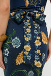 Close-up of Laguna Lavanda Midi Sarong's back, showcasing a classic floral pattern with an effortless, high-end navy-blue fabric and a fun bow-tied sash at the waist.