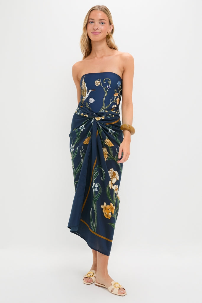 Woman models the Laguna Lavanda Midi Sarong, a classic, effortlessly styled piece with botanical motifs, perfect for fun, high-end occasions.