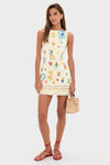 Young woman in Multi Sidi Beaded Mini Dress featuring classic high neckline and vibrant florals, styled with effortless red sandals and a fun woven handbag for a high-end look.