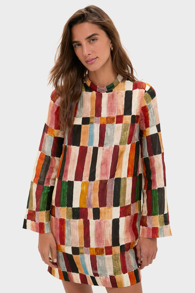 Woman in a classic, effortless Multi Marjorelle Mini Dress, featuring a relaxed silhouette with bead detailing, designed by Laurence Leenaert for a high-end, fun look.