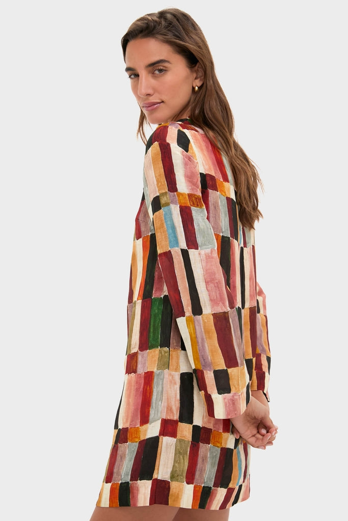 Model wears the classic Multi Marjorelle Mini Dress, featuring an effortless painterly checkerboard print, relaxed silhouette, and beaded neckline, embodying high-end, fun design.