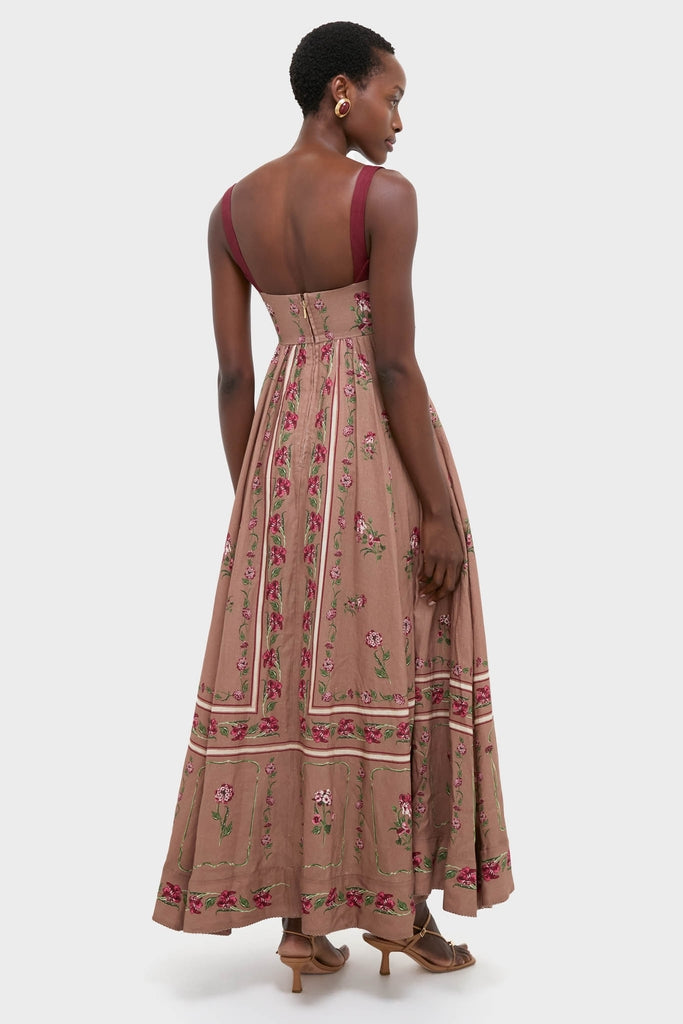 Woman models classic Quebrada Jaspe Maxi Dress, featuring an effortless A-line silhouette with rose embroidery, wide straps, and concealed back zip. Perfect for high-end, fun occasions.
