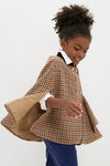 Young girl in a classic Checked Double Breasted Cape in Brown with a velvet collar, exuding effortless sophistication and fun, perfect for high-end, cool-weather adventures.