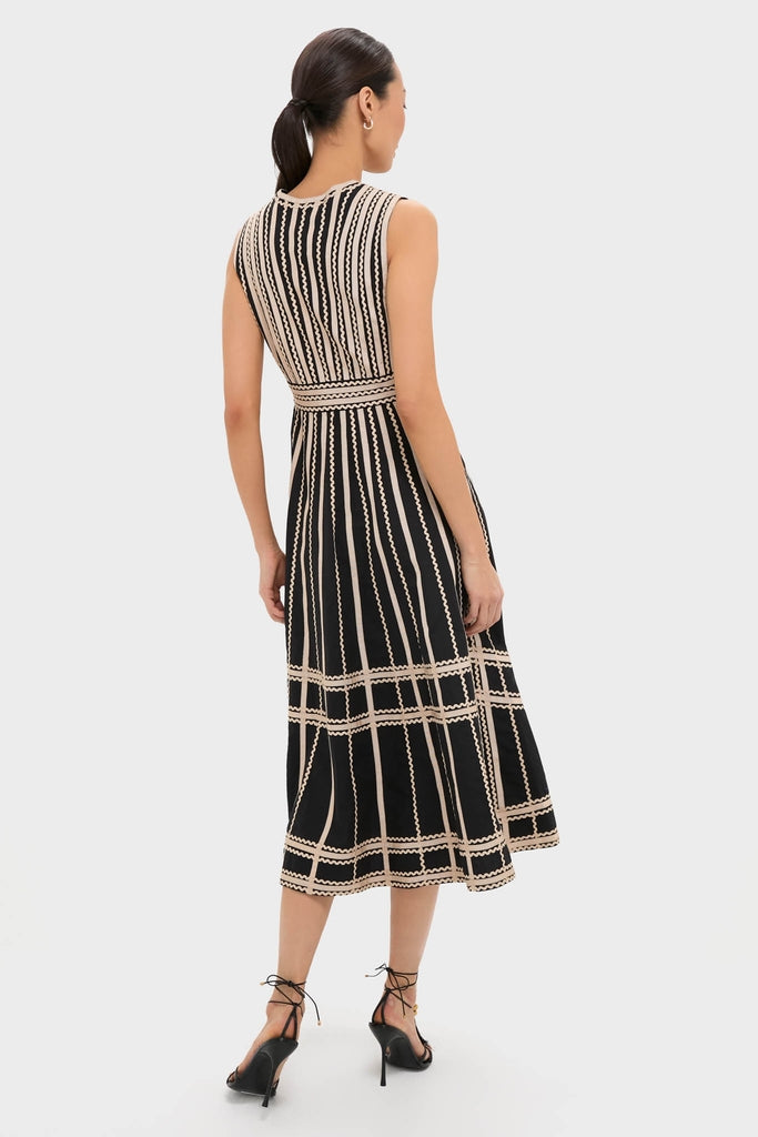 Model showcasing the Noir Palermo Dress with classic stitched-stripe detailing and an effortless A-line silhouette, paired with high-end lace-up heels for a fun, elegant look.